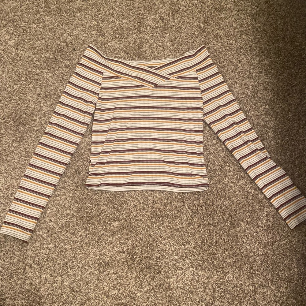 Off-the shoulders top, cream colored with grey,black,burgundy,and orange brown.